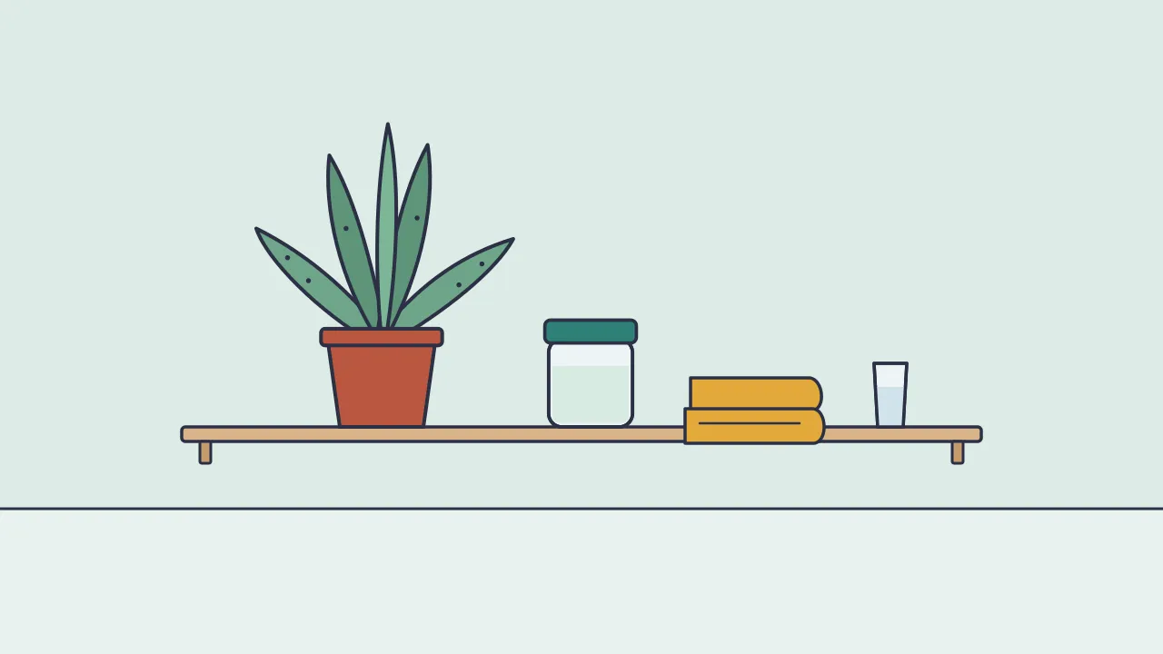 A potted aloe vera plant on a bathroom shelf beside a small jar of clear gel, a folded towel and a glass of water