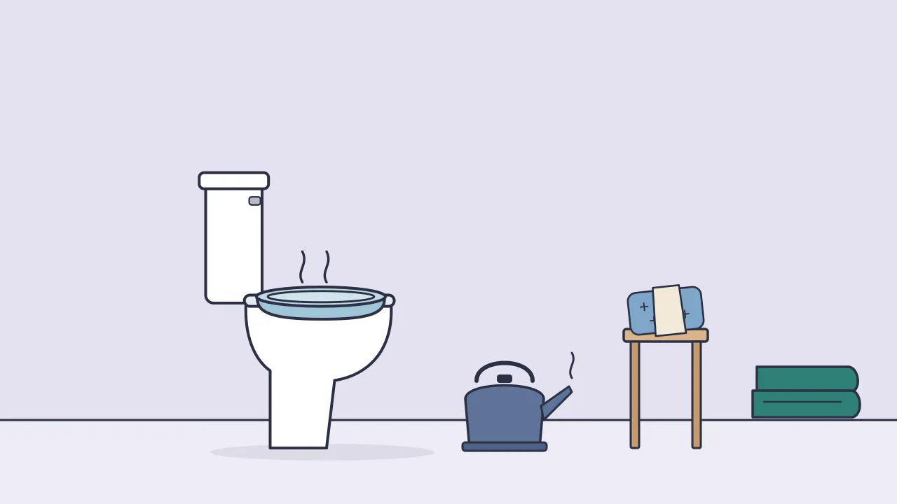 A sitz bath basin set on a toilet seat beside a kettle and towel, with a wrapped cold pack resting on a small stool nearby