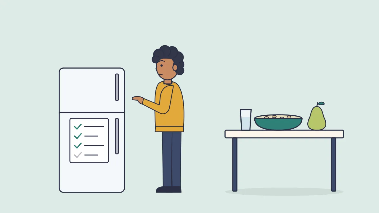 A person checking off a short list on a fridge whiteboard in a kitchen, with a glass of water, a bowl of oats and a pear on the counter