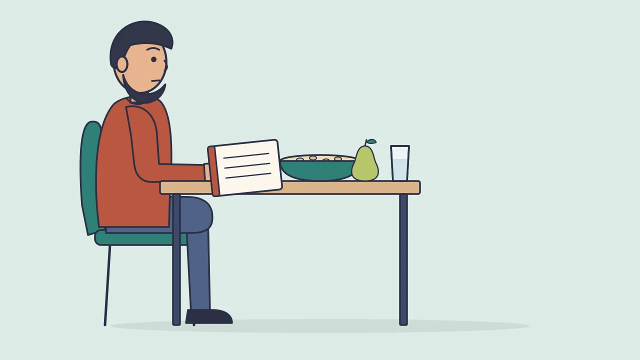 A person sits at a kitchen table with a bowl of porridge, a pear and a tall glass of water, reading a leaflet