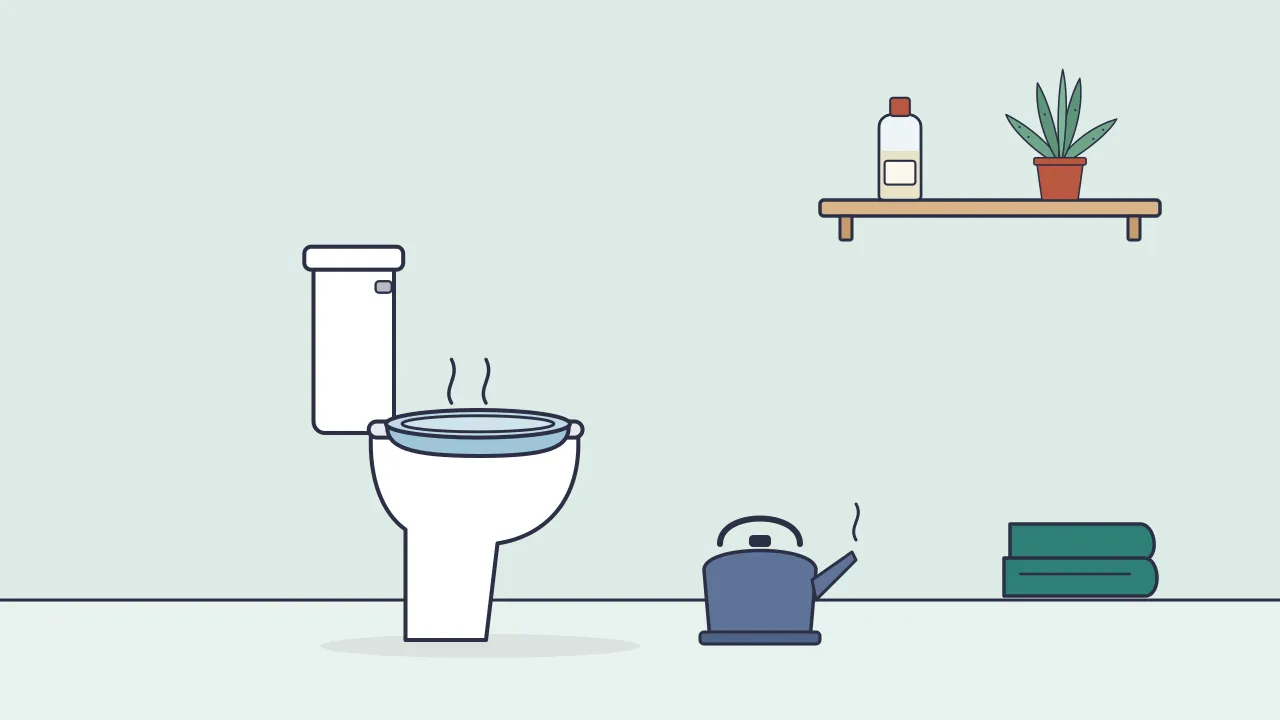 A sitz bath basin on a toilet seat next to a kettle and towel, with a bottle of witch hazel and a small aloe plant on a shelf above